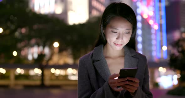 Business Woman Use of Mobile Phone in City at Night alt
