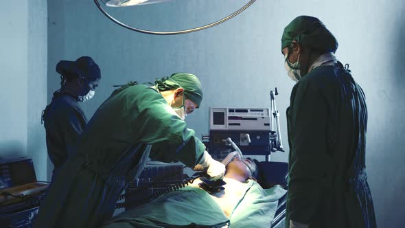 Surgical doctor team performing surgery patient on operating room in hospital alt