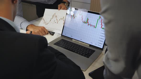 Company Boss Making Some Notes on Graph with Sales Result at Office