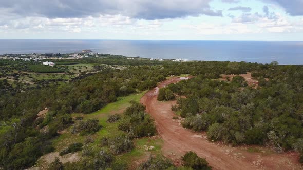 Aerial drone shot of the Akamas Peninsula of Cyprus in Paphos following a dirt path high in the hill alt
