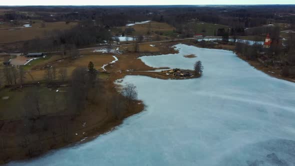 Araisi Lake Castle in Latvia Aerial Shot From Above. Historical Wooden Buildings on Small Island in alt