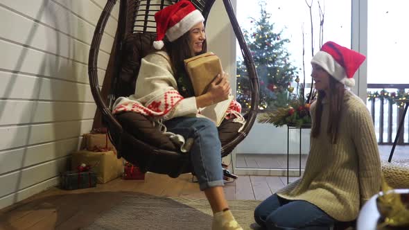 Two Girls Give Gifts To Each Other on New Year's Eve alt