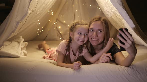 Happy Mom and Daughter Video Call Their Father From a Makeshift Tent at Home They Smile and Talk