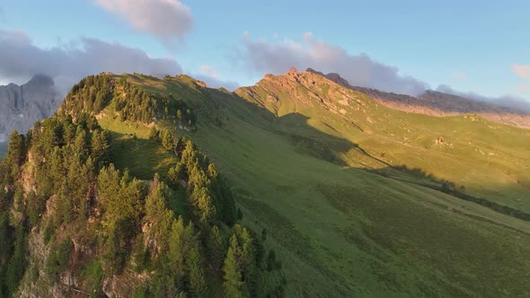 Dolomites mountains peaks with a hiking path on a summer sunrise