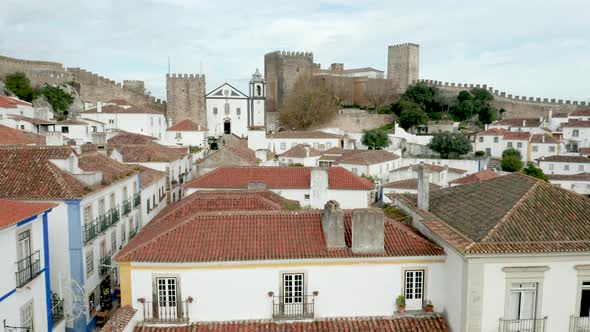Traditional Houses In The Medieval Town Of Obidos In Portugal - aerial sideways alt