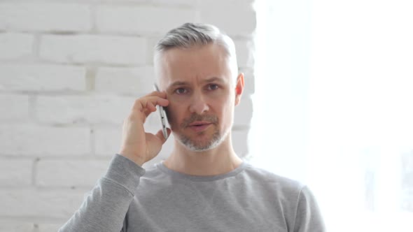 Middle Aged Man Talking on Phone, Negotiation on Mobile alt