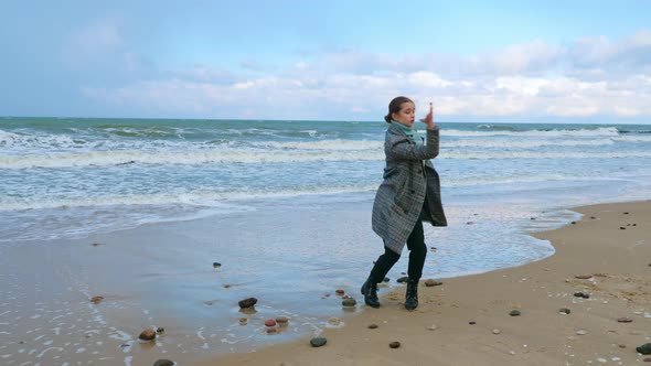A Woman Performing Dance Improvisation at the Seacoast