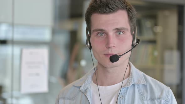 Portrait of Call Center Employee Wearing Headset and Smiling alt