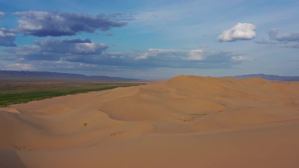 Aerial View of Sand Dunes in Desert at Sunset alt