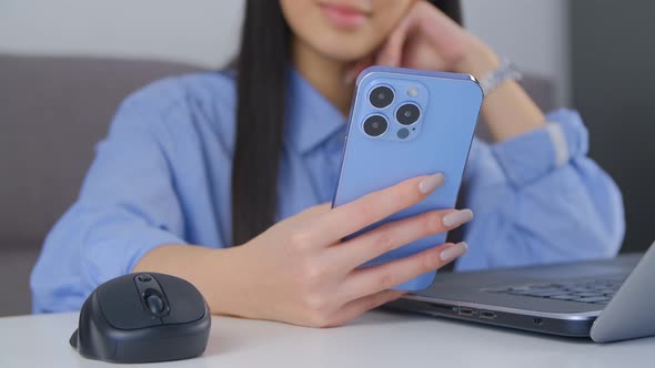 Beautiful young woman shopping online with smartphone. Girl browsing internet on mobile phone alt