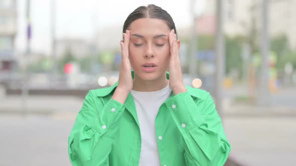 Portrait of Tense Hispanic Woman with Headache Outdoor alt