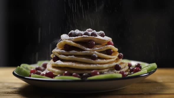 Pancakes Pile on Plate Dusted with Powdered Sugar alt
