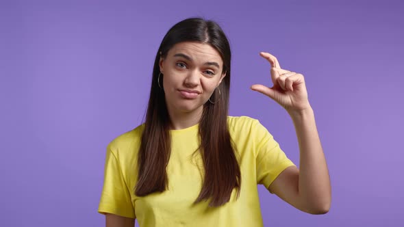 Young Woman Showing Difference Between Invisible Abstract Subject or Object Sizes alt