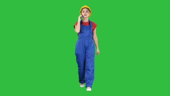 Female construction woman making a call on a Green Screen alt
