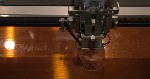 Close-up of mechanism of 3D printer working on printing plastic toys alt