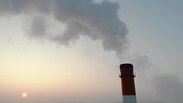 Smoke Coming From the Chimney Against the Background of the Evening Sky alt