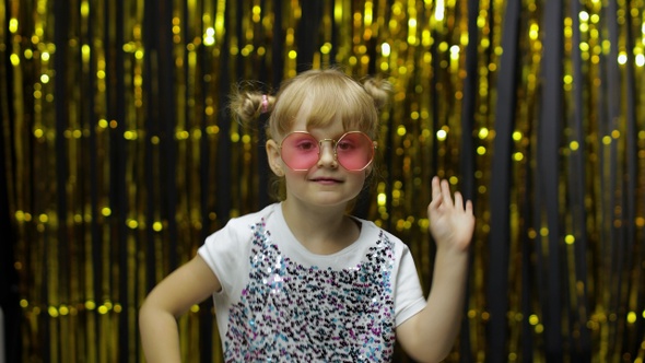 Child Kid Dancing, Celebrating Victory, Fooling Around. Girl Posing on Background with Foil Curtain alt