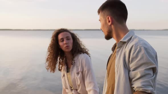 Walking Together Along Lake Shore alt