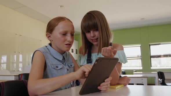 Two girls using digital tablet in the class alt