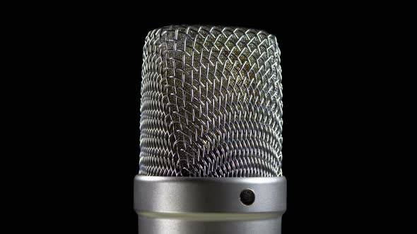 Studio Condenser Microphone Rotates on a Black Background alt