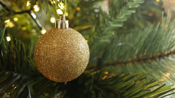 Close-up of  bauble with sequins on the artificial tree 4K 2160p 30fps UltraHD footage - Fairy-light alt