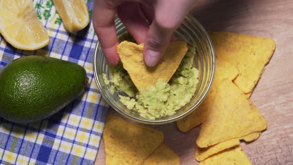 The Family Eats Traditional Mexican Guacamole Sauce with Chips, Top View. Vegan Snack From Unhealthy
