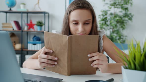 Slow Motion of Child Reading Interesting Book and Smiling Enjoying Funny Story at Home alt