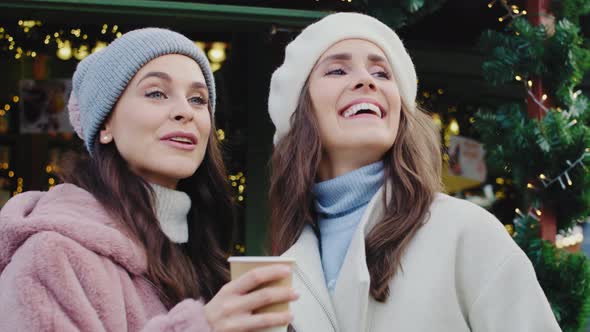 Handheld view of friends spending time on Christmas market alt