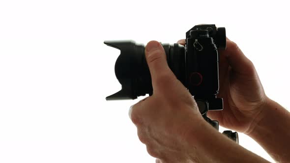 Photographer Adjust Settings and Focus on the Photo Camera and Makes Photo alt