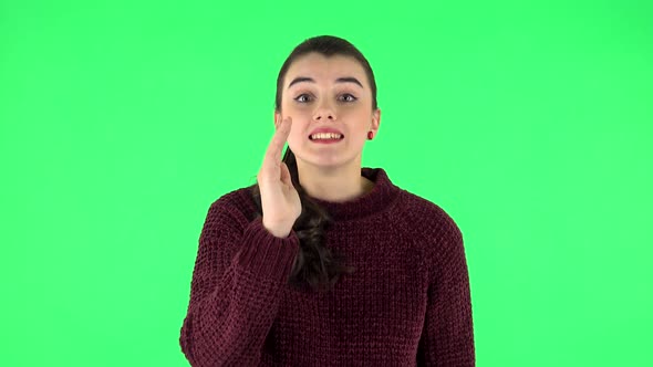 Girl Screams Calling Someone on a Green Screen at Studio. Green Screen alt