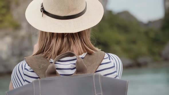 Handheld view of female tourist using mobile phone. Shot with RED helium camera alt