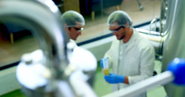 Two brewers discussing with each other at brewery factory 4k alt