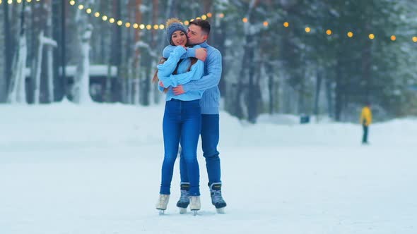 Couple Hugs Standing on Outdoor Skating Rink