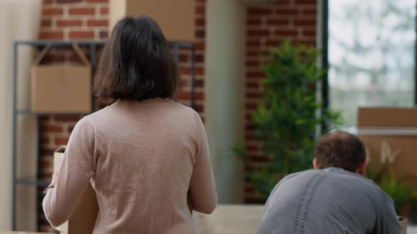 Married Couple Carrying Carton Boxes in Apartment Flat alt