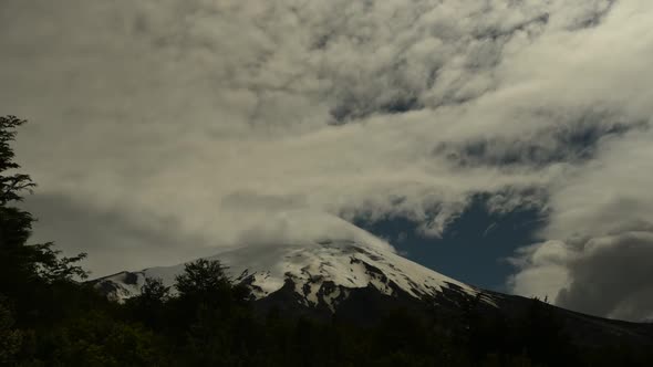 Time lapse of clouds swirling around the peak of Osorno volcano in Chile alt