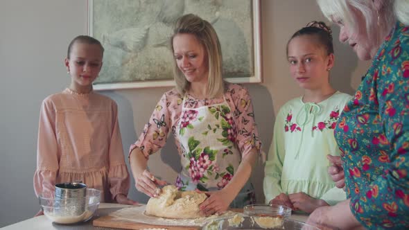 Portrait of Happy Three Female Generations Kneading Dough in Parents Home alt