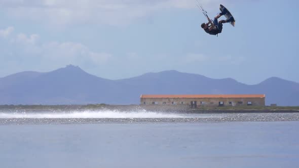 A man kiteboarding on a kite board. alt