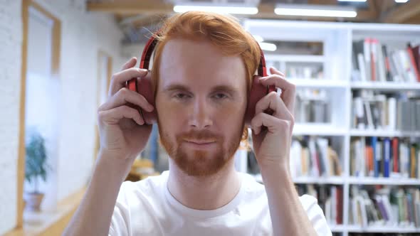 Young Man Wearing Headphones to Listen Music alt