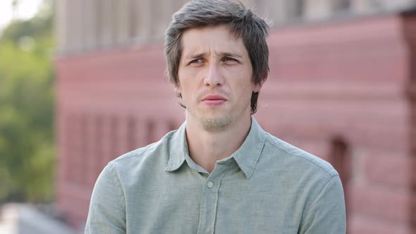 Headshot Closeup Portrait Unhappy Young Caucasian Guy Sniffing Air Closing Nose Holding Breath alt