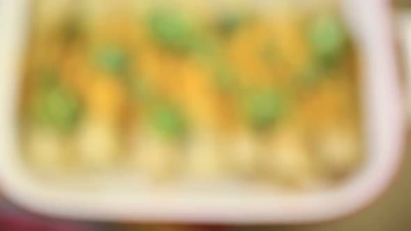 Chicken enchiladas with cheddar cheese and sauce. alt