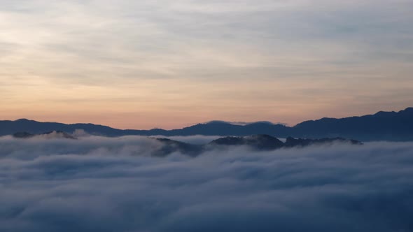 Landscape of mountains and hills with the sea of fog before sunset.