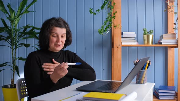 Middle Aged Old Woman Looking at Pregnancy Test alt