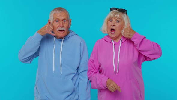 Senior Grandfather Grandmother Looking at Camera Doing Phone Gesture Like Says Hey you Call Us Back alt