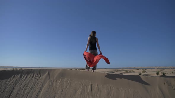 Standing on top of a windy sand dune in Morocco. alt