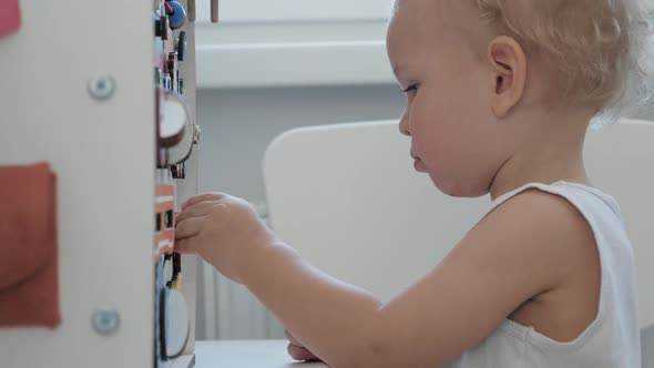 Small Baby Child Plays With Toys In The Nursery alt