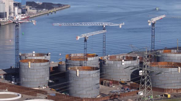 Construction cranes at new oil storage terminal, Rotterdam Port; drone view alt