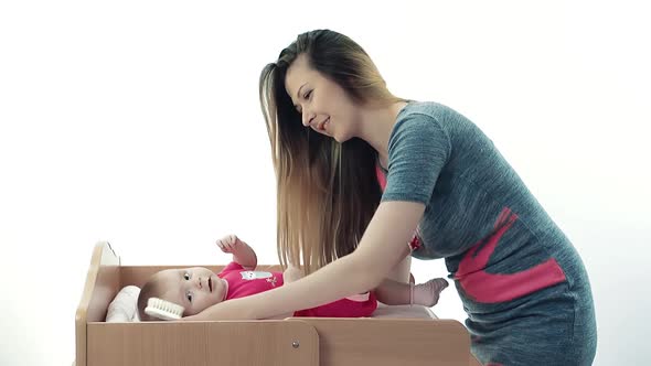 Mother Combing Her Baby Hair alt