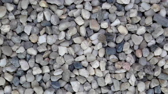 Background of Large Pile Gray Gravel Stone Pebbles Used in Construction Turning Slowly alt