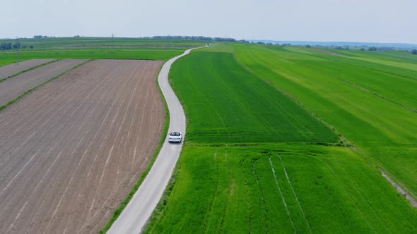 Car Driving On A Green Field