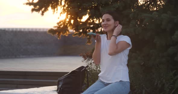 Young Beautiful Smiling Woman Talks on Mobile Telephone City Street Cars Taxi Audio Message Voice alt